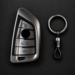 BMW gloss silver TPU key cover and chrome barrel keyring set on dark background