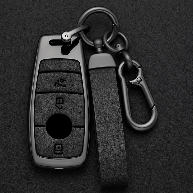 Mercedes-Benz gunmetal zinc alloy key cover and leather carabiner keychain set on dark background